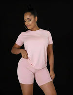 Cargar imagen en el visor de la galería, Woman wearing a pink outfit on a gray professional photo background
